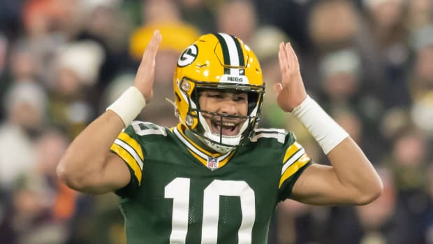 Green Bay Packers quarterback Jordan Love gestures while making a call at the line.
